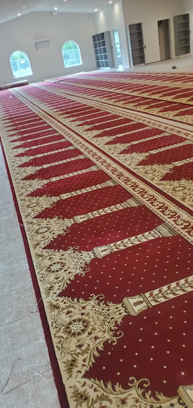 Patterned carpet being installed in a large interior