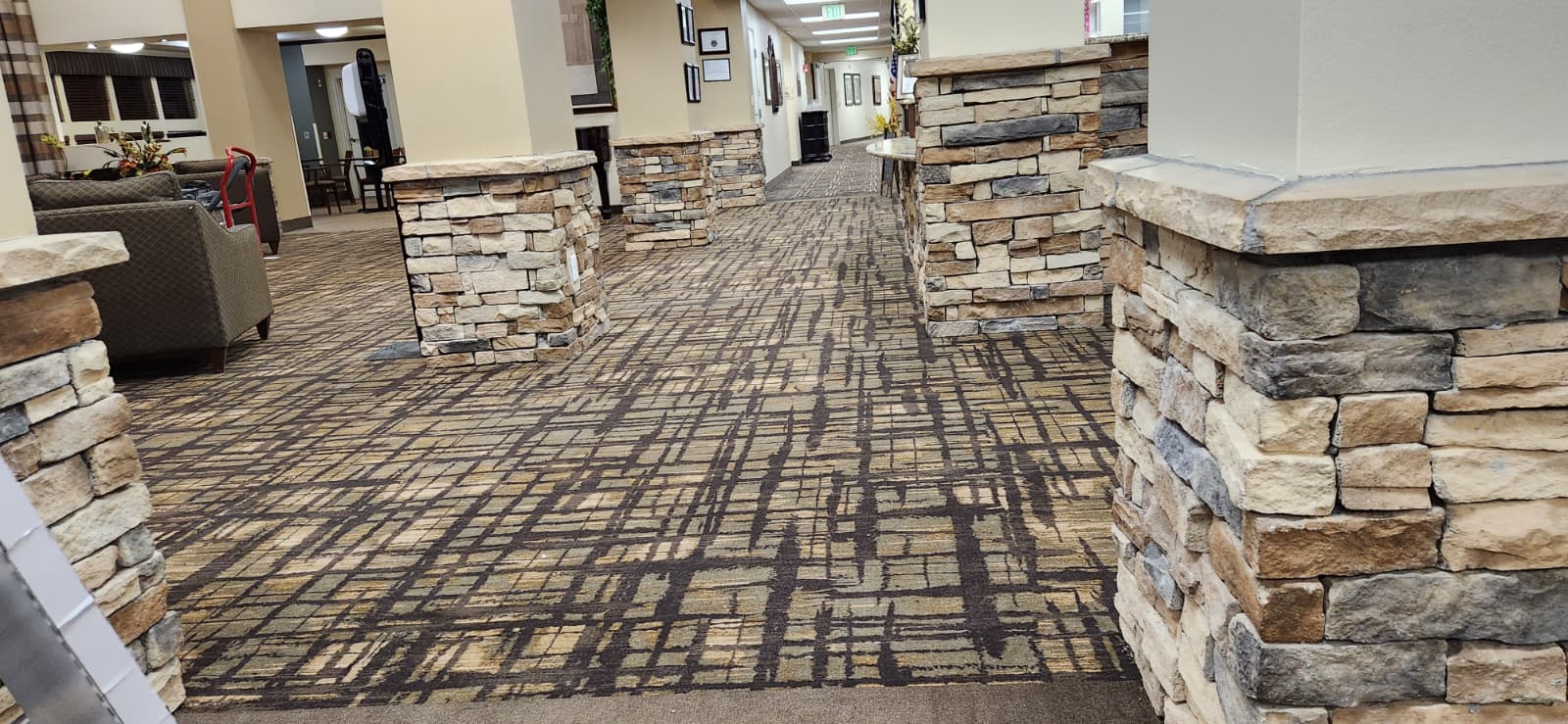 Patterned carpet tile through a furnished commercial corridor