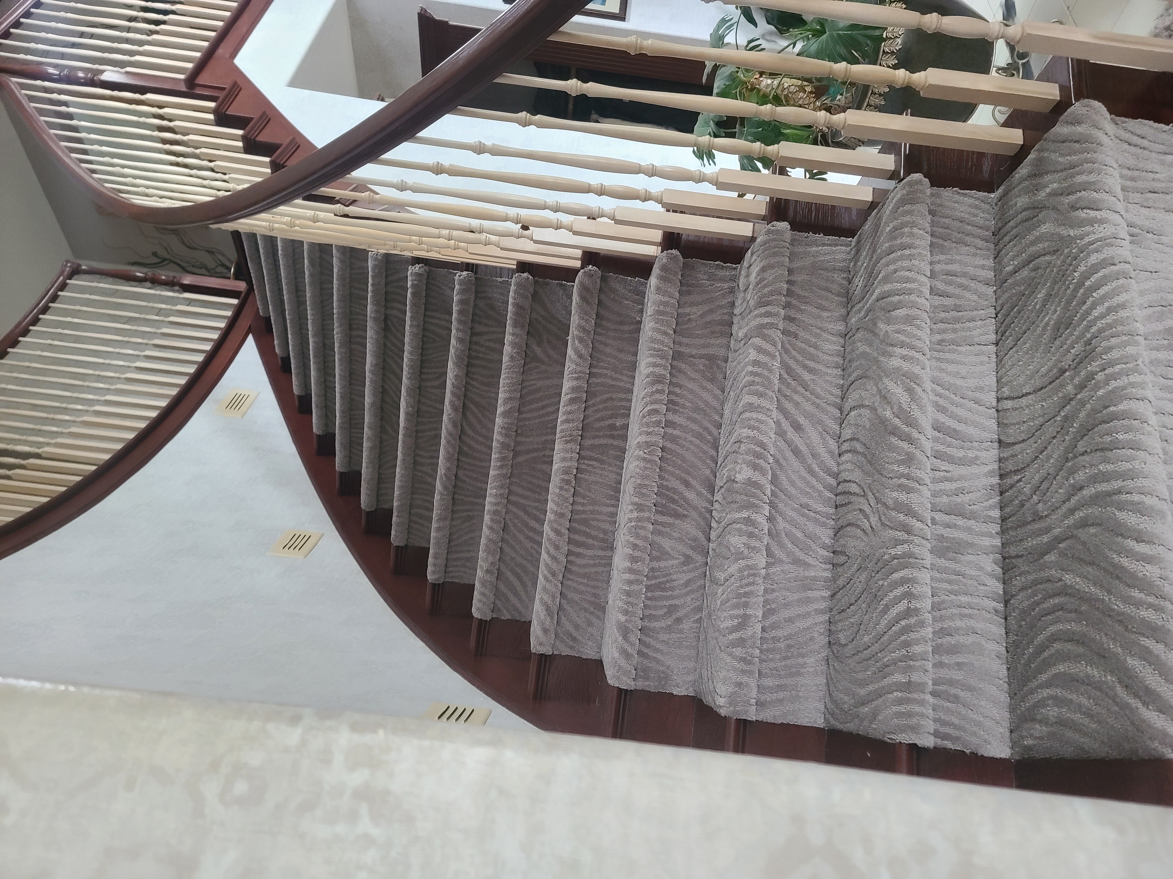 Patterned carpet covering a curved staircase