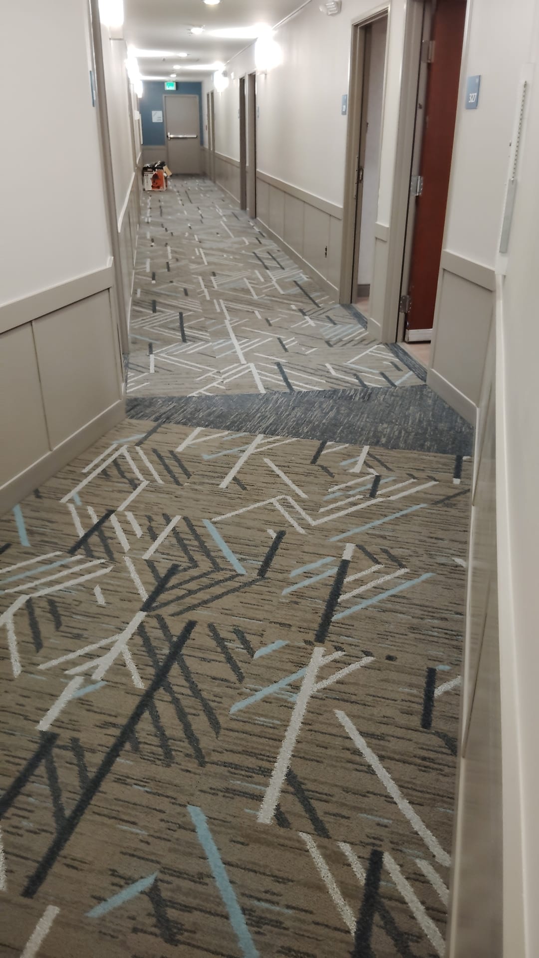 Patterned carpet along a finished building hallway